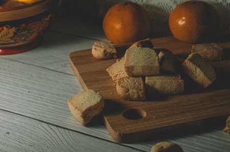 Still life homemade shortbread cookies on a wooden board. The focus is on the cookies on the boardの写真素材