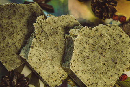 Three pieces of handmade soap lying on the table. The focus is set on the top parts of the soap.の写真素材