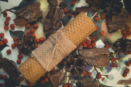 Wax candle handmade close-up. Festive decor of berries and bark.の写真素材
