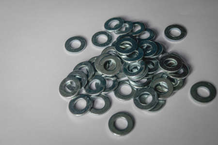 A scattering of metal washers for bolts and screws. High quality photoの写真素材