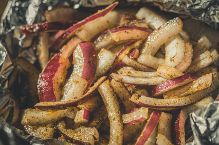 Pickled red onion. Cutting red onions in foil for baking in the oven. Cooking. Selective focusの写真素材