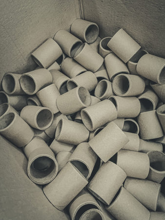 Cardboard spools for winding. Reels made of cardboard. Background of cardboard bobbins. Defocused,...