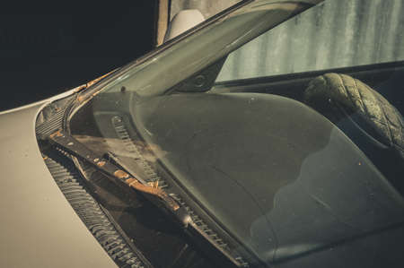 Close-up of the windshield and wipers of an old car. Dust, rust and dirt on surfaces. Selective focusの写真素材