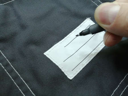Patch on work clothes to write the name of the owner. Close-up of a clean name patch. Name tagの写真素材