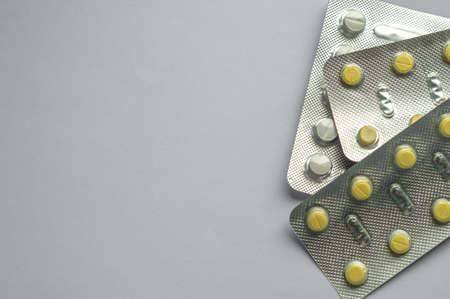 Tablets for colds on a gray background with copy space. Medicines. Means of treatment of diseases.の写真素材