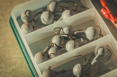 A set of fishing cargoes with hooks of different weights. Fishing box with accessories. Selective focusの写真素材