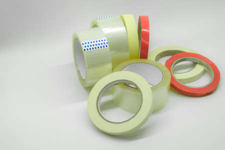 Adhesive tape of different types and sizes. Transparent and colored paint tape. Stationery and construction supplies. Selective focusの写真素材