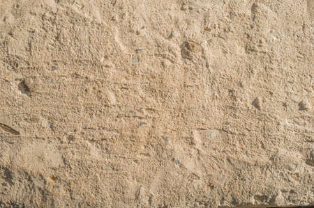 Old concrete pavement with potholes. Beige tone of the coating. Abstract backgroundの写真素材