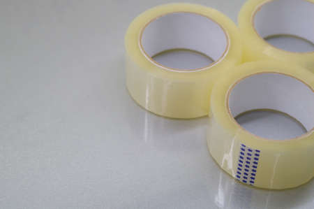 Three rollers of transparent tape. Stationery and packaging consumables. Selective focus.の写真素材