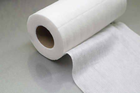 Universal white fabric napkins for cleaning in a roll. Bobbin with napkins for dispenser. Selective focusの写真素材