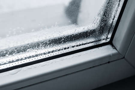 Drops of condensate on a defective plastic window. Selective focus.の写真素材