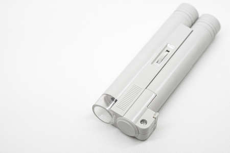 Compact mini microscope for printing and design. Magnifying device. Selective focus, copy space, white backgroundの写真素材
