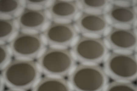 Abstract background blurred cardboard sleeves. Defocused spools and bobbins for winding paper.の写真素材