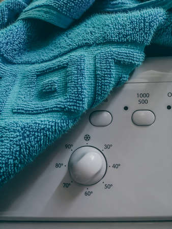 Control panel of the washing machine under a blue towel. Selective focusの写真素材
