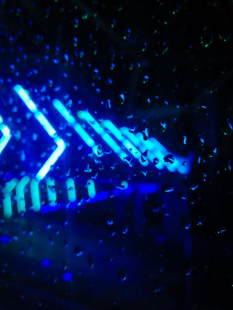 Abstract background with LED light and water streaks on the glass