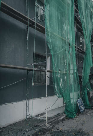 Reconstruction of the facade of a residential building. Construction works in the city. Grain and noise.の写真素材