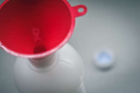 Blurred red funnel in a plastic bottle. Selective focus, copy spaceの写真素材