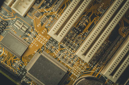 Computing chip on an old motherboard. Old electronics close-up. Selective focus, dustの写真素材