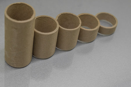 Cardboard spools for winding. Reels made of cardboard. Background of cardboard bobbins. Selective...