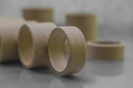 Cardboard spools for winding. Reels made of cardboard. Background of cardboard bobbins. Selective focusの写真素材