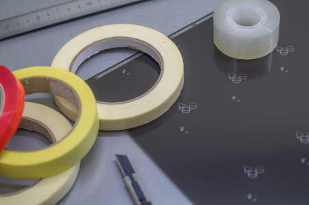 Blurred adhesive tape of different types and sizes. Transparent and colored paint tape. Stationery and construction supplies. Selective focusの写真素材