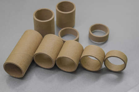 Blurred cardboard spools for winding. Reels made of cardboard. Background of cardboard bobbins. Selective focusの写真素材