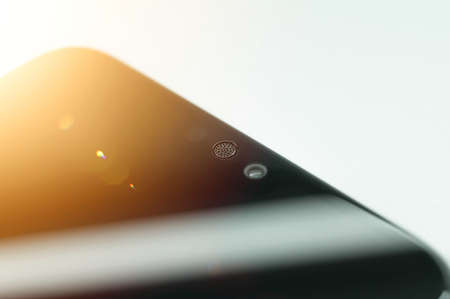 Smartphone micro speaker above the screen close-up. The top of the mobile phone with a built-in camera and speaker. Selective focusの写真素材
