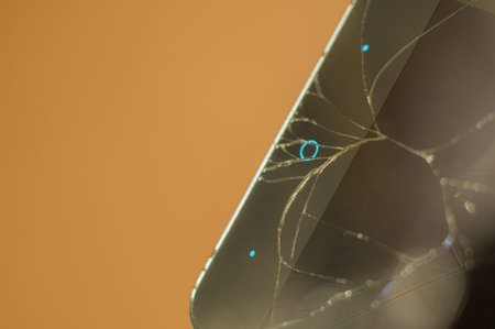 Smartphone with broken display glass. Cracked screen glass. Broken phone. Selective focus