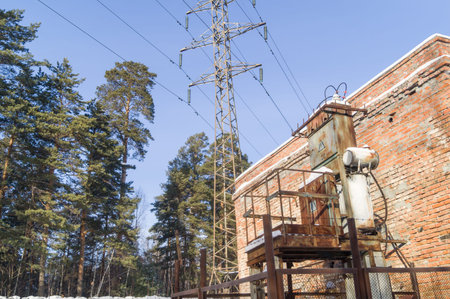 Old high-voltage transformer of city power supply. Rusty equipment of the power plant. Selective...