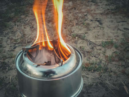 Mini camping stove. Tourist equipment for cooking. Selective focus, copy spaceの写真素材