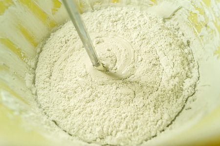 White putty in a bucket of water. Preparation of mortar for finishing walls and ceilings in the apartment. Repair in the house. DIY. Selective focusの写真素材