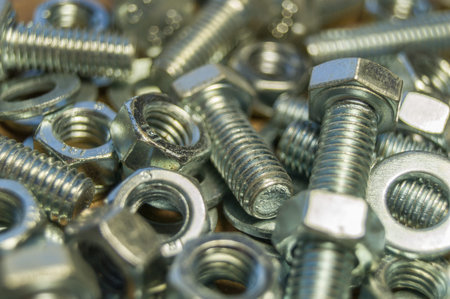 Various hardware. Metal fasteners. Bolts, nuts and washers. Soft focus, abstract, industrial...