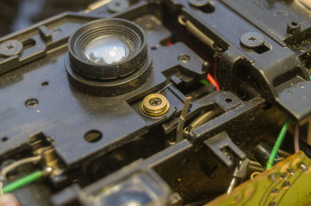 Disassembled compact camera. Internal parts of the broken camera being repaired in the workshop. Selective focusの写真素材