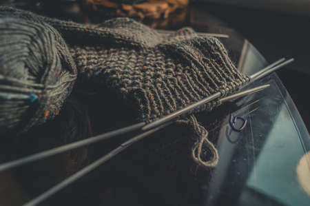 Knitting wool sock. A ball of natural yarn made of wool. His hobby is hand knitting. Selective focus, black backgroundの写真素材
