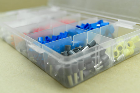 A set of colored crimp terminals for electrical wires. Crimping sleeves of different sizes. Plastic...