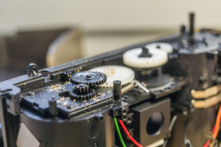 A group of gears of a compact camera to be repaired. Cleaning the gears inside the electronics....