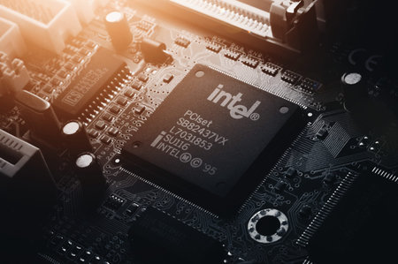Russia, Berdsk - 17 feb 2021: Intel computing chip on an old motherboard. Old electronics close-up. Chip ICS. Electronic background. Selective focusのeditorial素材