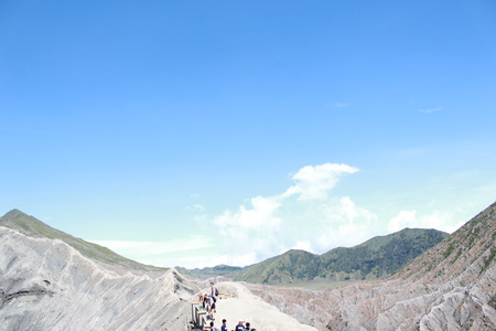 Tourists at the crater of Mount Bromo at sunrise in Bromo Tengger Semeru National Parkの写真素材