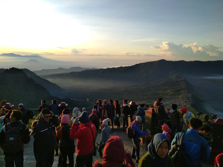 Tourists enjoy views of the valley of Mount Bromo at sunrise, in East Java, Indonesiaのeditorial素材