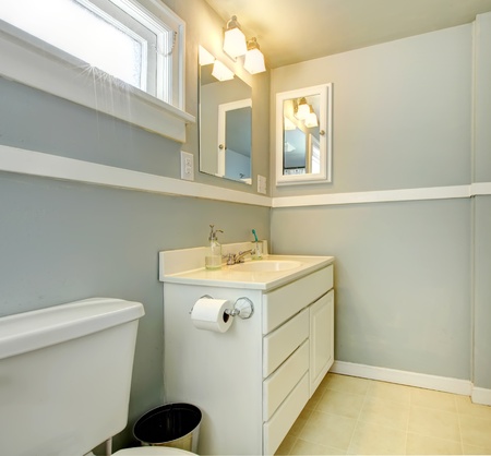 Grey bathroom with white simple cabinet and toilet.の写真素材