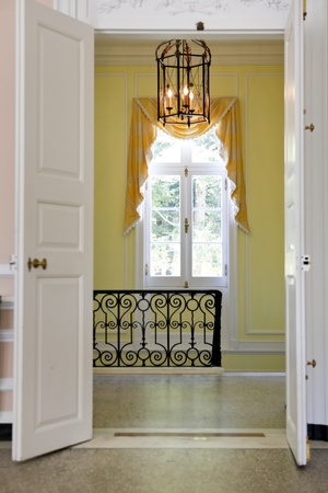 Historical home details with open doors, window and staircase の写真素材
