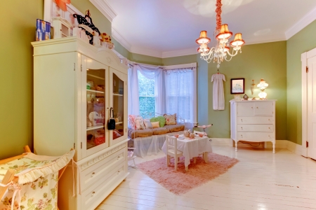 Charming antique baby room with green and white colors.の写真素材