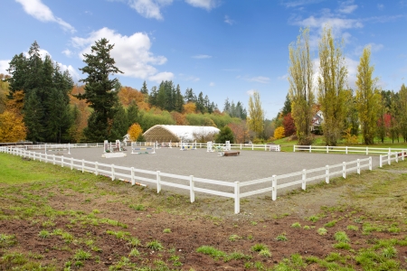 Northwest horse rach with fall changing leaves and white fence.の写真素材