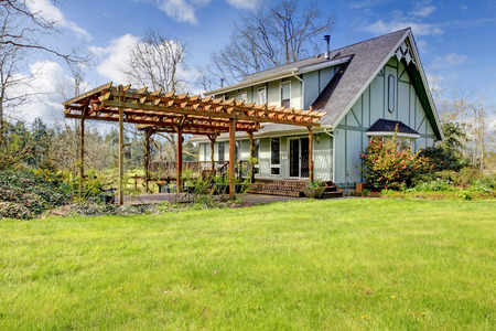 Designed rustic farmhouse with open front deck and attached wood pergolaの写真素材