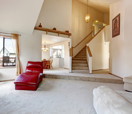 High Vaulted Ceiling Living Room With Hallway And Stairs Open To