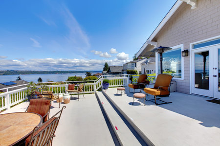 Large white house terrace with water view during summer.の写真素材
