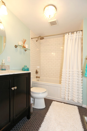 Aqua bathroom with dark floor and tile wall trim. View of bathroom vanity with mirrorの写真素材