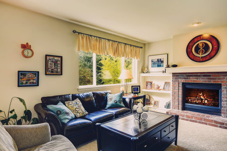 Living room interior with brick background fireplace, leather furniture set and black coffee table with drawers