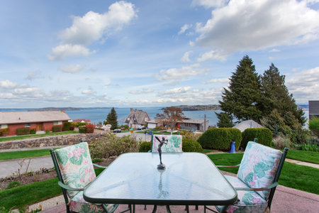 Backyard deck with table set and beautiful view of lake