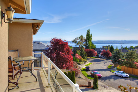 Walkout deck with table and chairs overlooking driveway and bayの写真素材